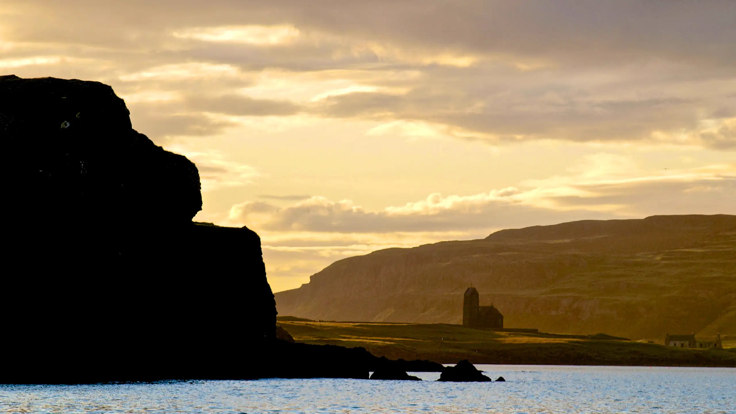Canna harbour with the church on Sanday in the background