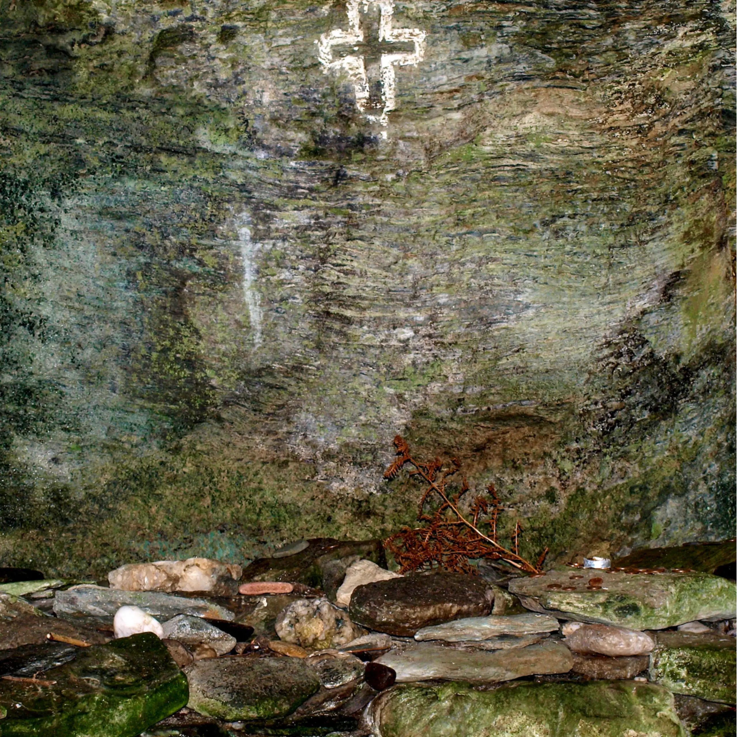 A cross carved on the wall of the largest cave