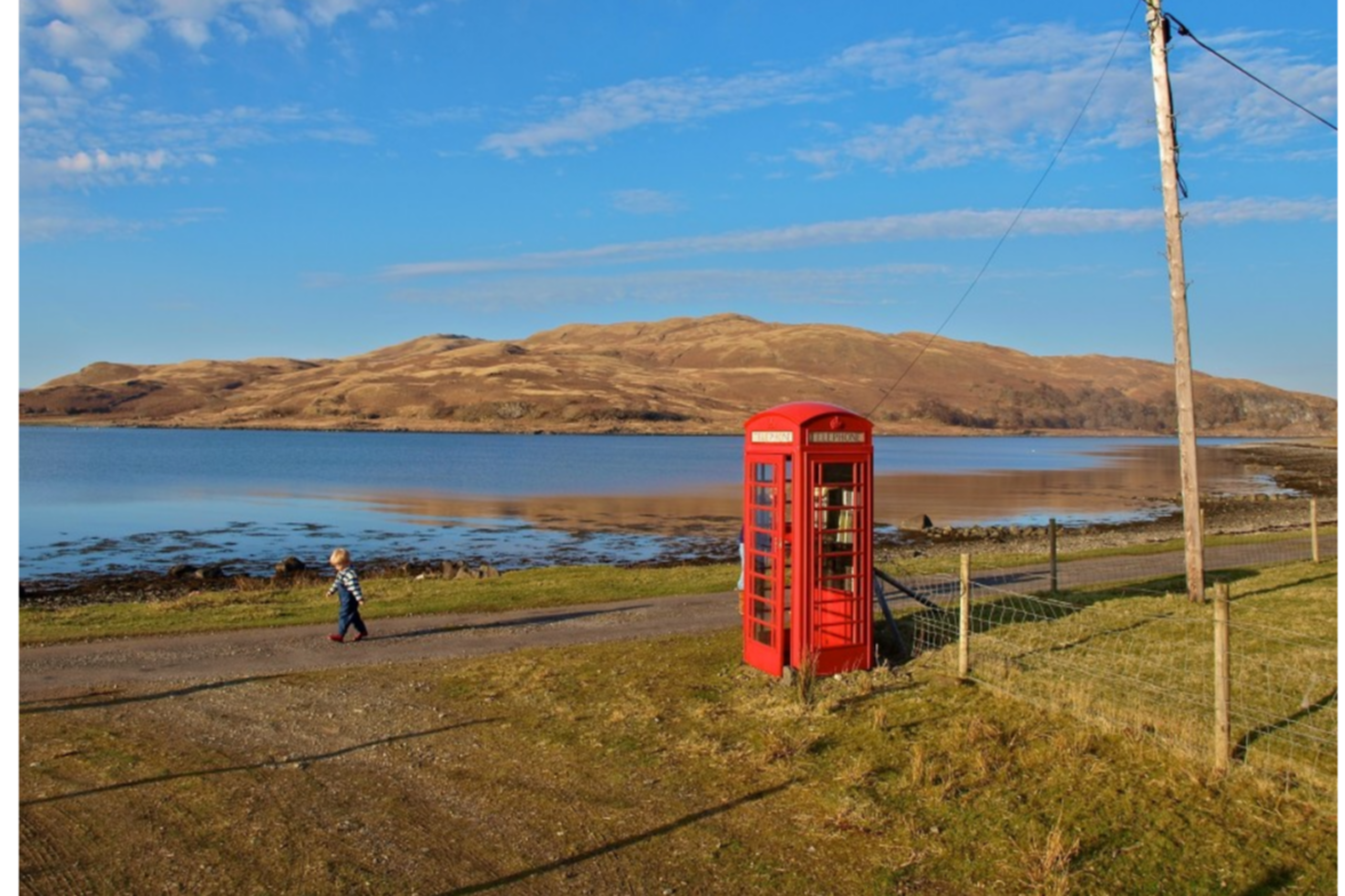 Striding past the old red telephone box