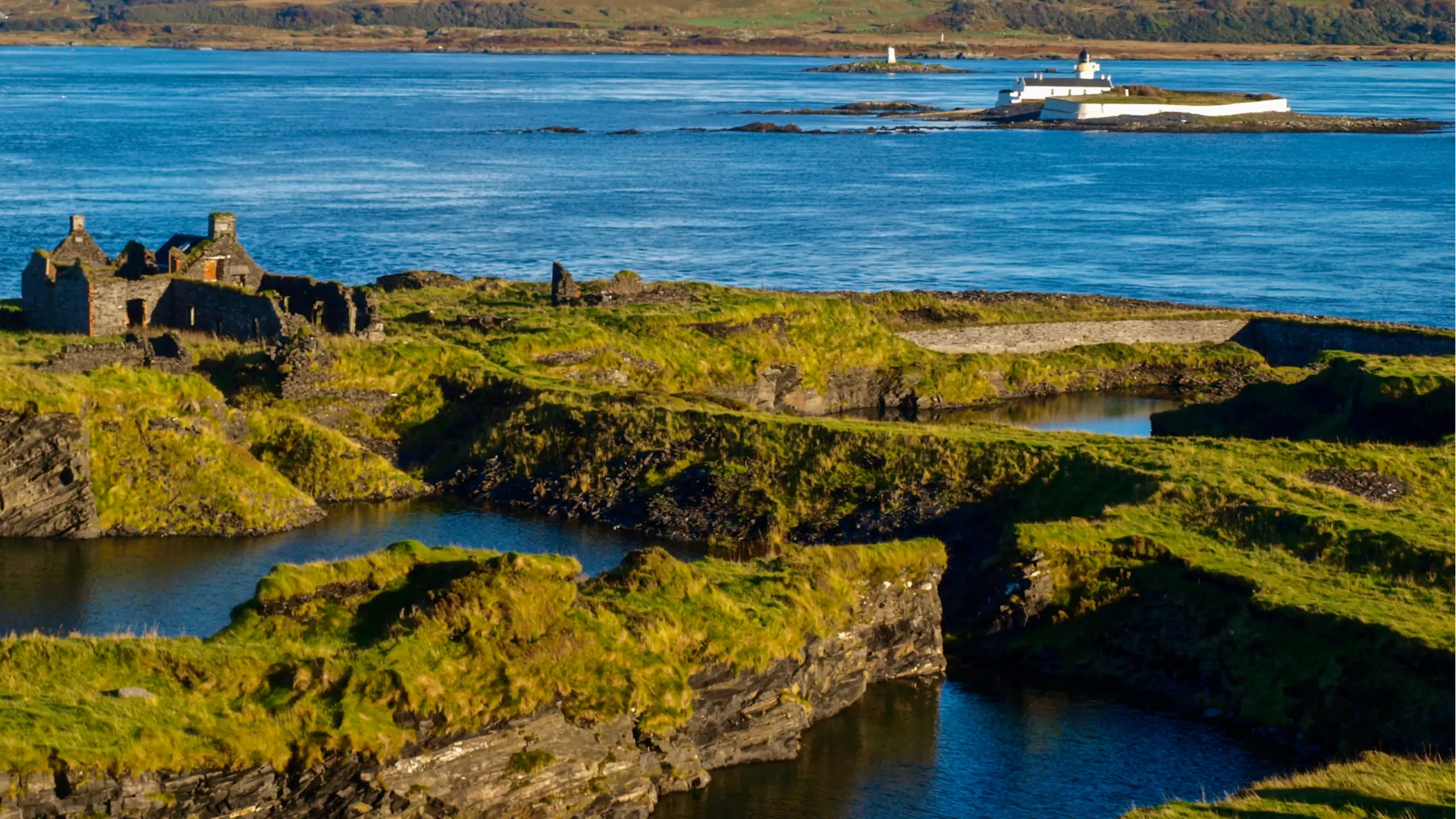 Flooded slate quarries, and looking over to the Fladda light